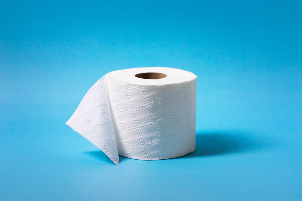 portfolio-02 A single roll of toilet paper is isolated against a vibrant blue background, offering ample copy space.