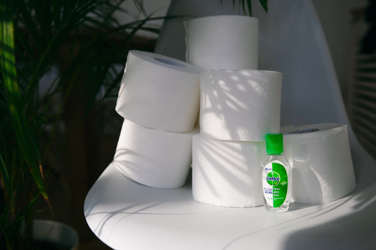 portfolio-06 A still life with toilet paper rolls and hand sanitizer in natural light indoors.